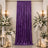 Purple velvet wedding backdrop with white floral arrangements and candles