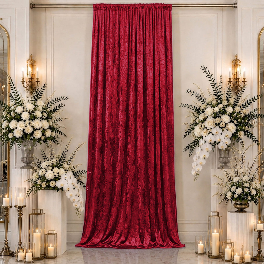 Elegant red velvet curtain with white floral arrangements and candlelit decor