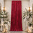 Elegant red velvet curtain with white floral arrangements and candlelit decor