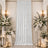 Elegant white wedding backdrop with floral arrangements and candle decor