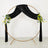 Gold circular backdrop with black velvet drapes and floral arrangements