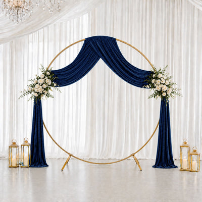 Navy blue and gold wedding arch backdrop with white floral accents