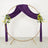 Purple draped round wedding arch with floral accents on gold frame