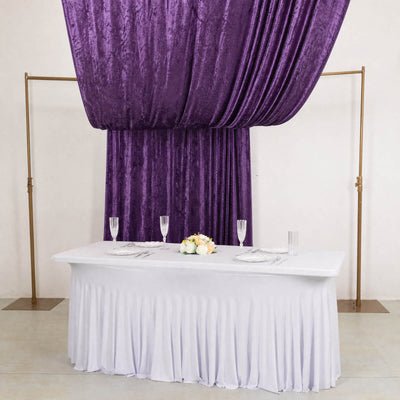 Purple velvet draped wedding table backdrop with white table setting