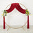 Gold round wedding arch with red velvet drapes and floral accents