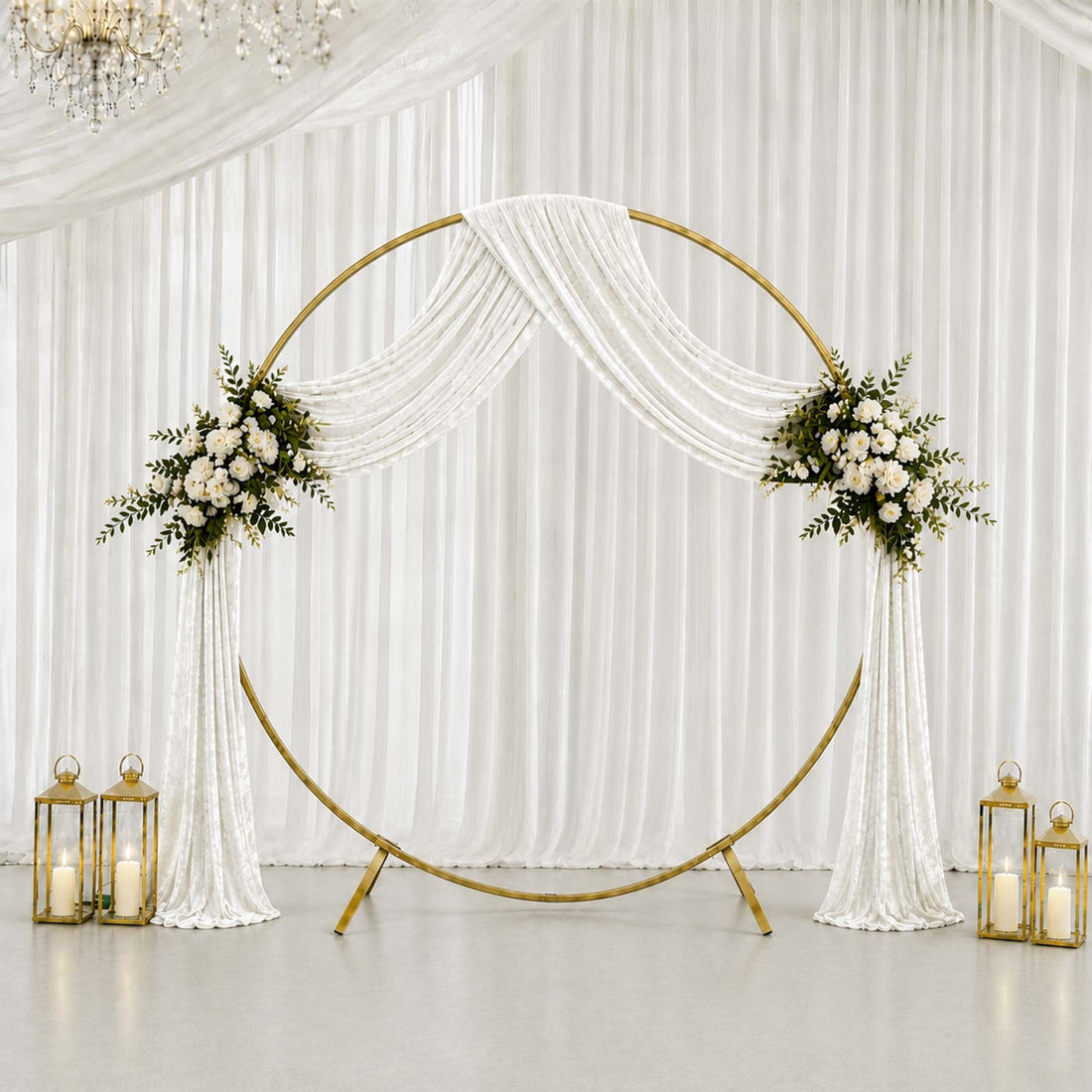 Elegant wedding circle backdrop with white drapes, floral arrangements, and lanterns