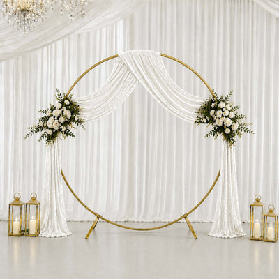 Elegant wedding circle backdrop with white drapes, floral arrangements, and lanterns