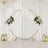 Elegant wedding circle backdrop with white drapes, floral arrangements, and lanterns