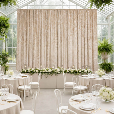 Elegant greenhouse wedding reception with cream drapery and floral tablescape
