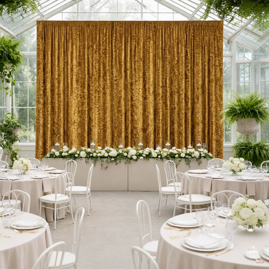 Elegant wedding reception with gold velvet backdrop, white florals, and round tables