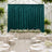 Elegant wedding reception with teal velvet backdrop, white florals, and round tables
