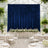 Elegant wedding reception with navy blue backdrop and white floral table decor