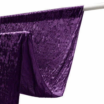Purple velvet curtain draped over a silver rod on white background