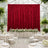 Elegant wedding reception with red velvet backdrop and white floral table decor