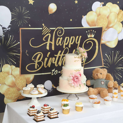 Birthday celebration setup with cake, cupcakes, and decorations.