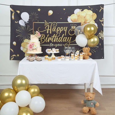 Birthday celebration setup with cake, balloons, and treats on a festive table.