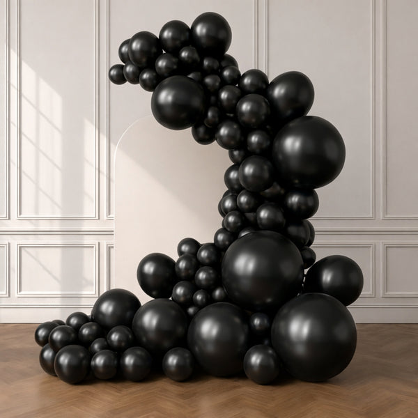 Black balloon sculpture in a modern interior setting.