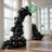 Black biodegradable balloons arranged in elegant archways for events.