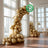 Eco-friendly biodegradable gold balloon arch for events and celebrations.