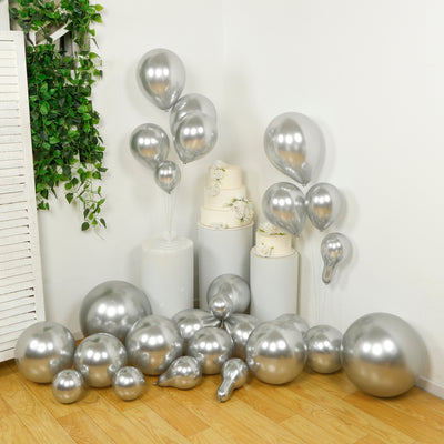 Silver balloons in various sizes, arranged artistically for a celebration.
