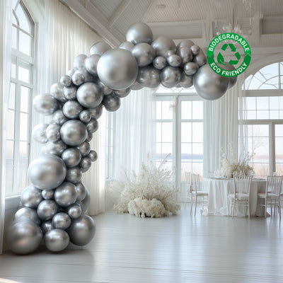 Silver biodegradable balloon arch in a bright event space. Eco-friendly decoration.