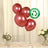 Set of four biodegradable rose gold balloons on a table with flowers.