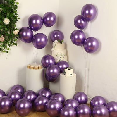 Purple balloons in a festive setting with a cake and floral decor.