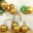 Gold biodegradable balloons in a festive arrangement with cake and decor.