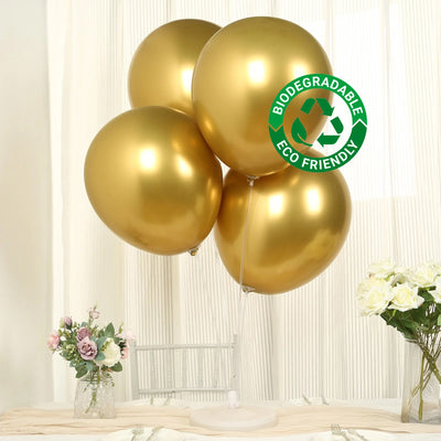 Gold biodegradable balloons with eco-friendly label on a table.