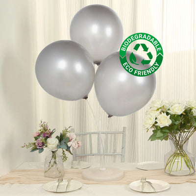 Silver biodegradable balloons with eco-friendly label, set against a soft backdrop.