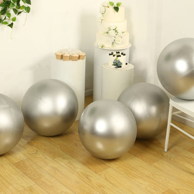 Silver decorative balls arranged in a bright, stylish room setting.