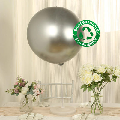 Silver biodegradable balloon with eco-friendly label on a table setting.