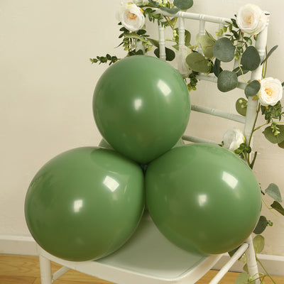 Three green balloons arranged on a chair with floral decorations.