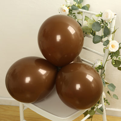 Brown balloons arranged on a chair with floral decor.