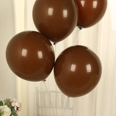 Brown balloons in a cluster against a soft backdrop.