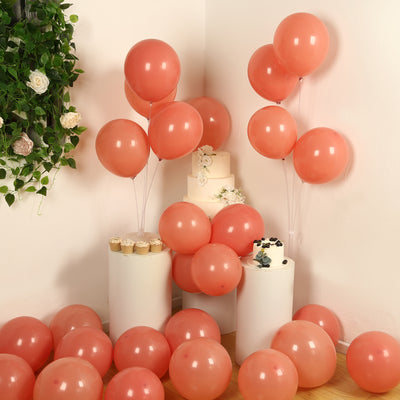 Pink balloons and cake displayed in a festive setting with decorative elements.