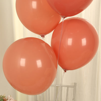 Four peach-colored balloons floating against a light background.