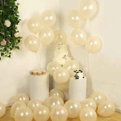 Cream balloons and cake with cupcakes at a festive celebration scene.