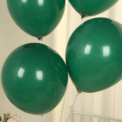 Green balloons floating in a bright indoor setting.