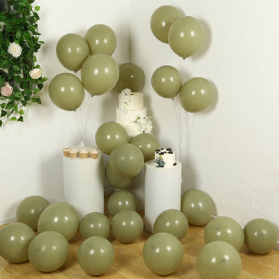 Decorative green balloons with cakes and cupcakes in a festive setup.