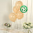 Peach biodegradable balloons on a table with flowers