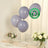Purple biodegradable balloons on a table with flowers, eco-friendly design.