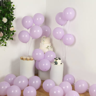 Lavender balloons arranged with a cake and cupcakes for a festive celebration.