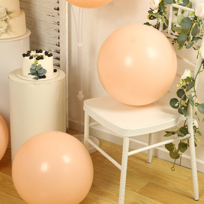Peach balloons on a chair in a decorated setting.