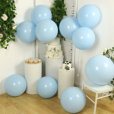 Blue balloons in a festive setting with cake and floral decorations.