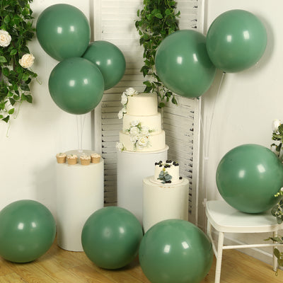 Green balloons and cakes in a decorated setting for a celebration.