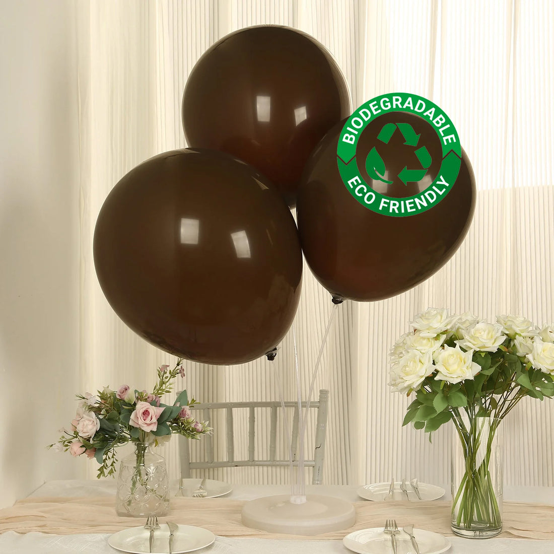 Brown biodegradable balloons displayed with flowers in a decorated setting.