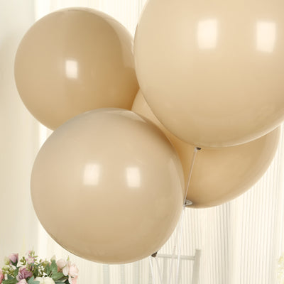 Beige balloons floating in a bright setting.