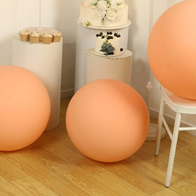 Peach-colored decorative balls in a styled interior setting.