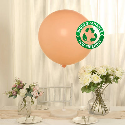 Biodegradable peach balloon with eco-friendly label on a table setting.